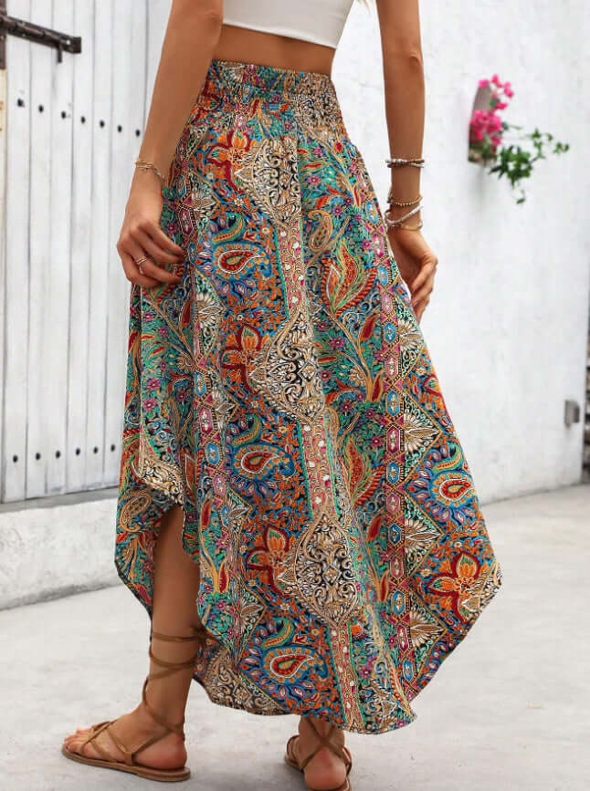 Boho ladies printed skirt with asymmetrical cut and chevron print, perfect for summer fashion in vibrant colors, worn with sandals.