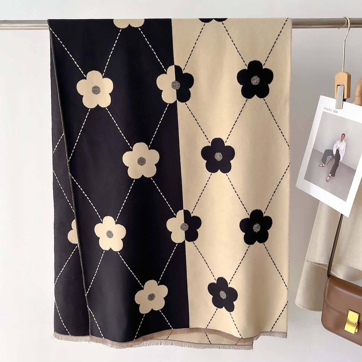 Elegant Imitation Cashmere Scarf with floral pattern, showcasing a blend of classic black and khaki colors, hung on a rack.
