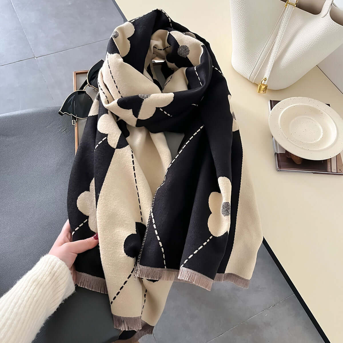 Elegant black and cream imitation cashmere scarf with floral pattern, ideal for versatile fashionistas. High-quality warp-knit design.