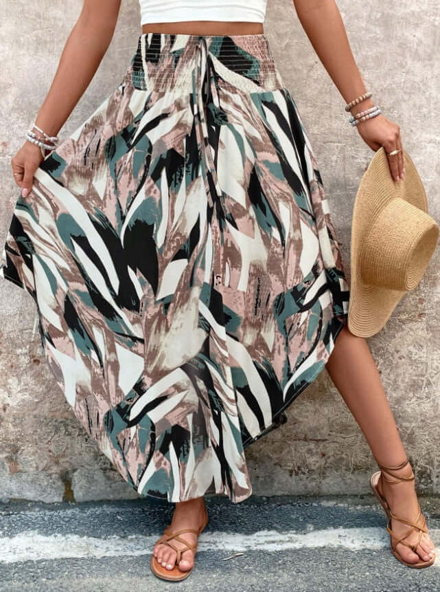 Woman wearing dark green chevron Ladies Printed Skirt with asymmetrical cut and elegant knot, showcasing boho style and comfort.