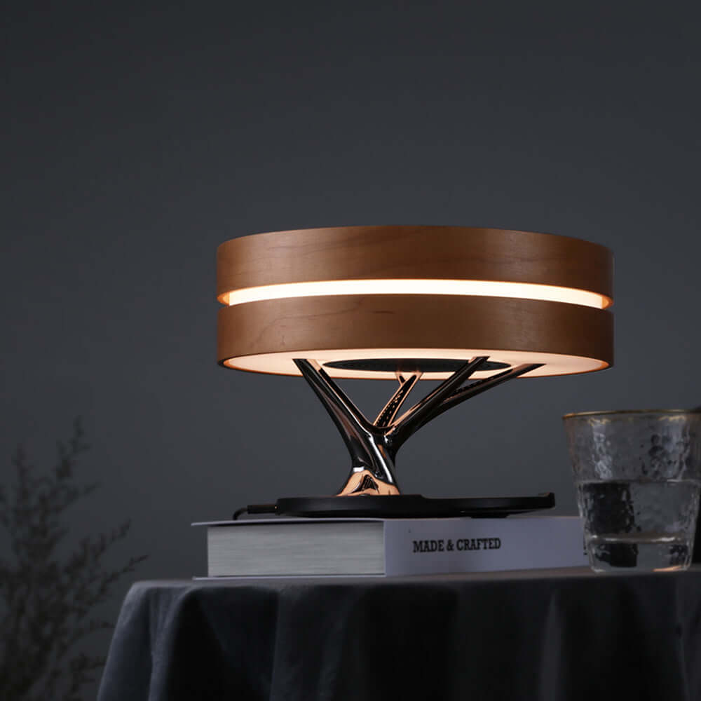 Stylish all-in-one intelligent desk lamp, music box, and wireless charger enhancing modern workspace aesthetics.
