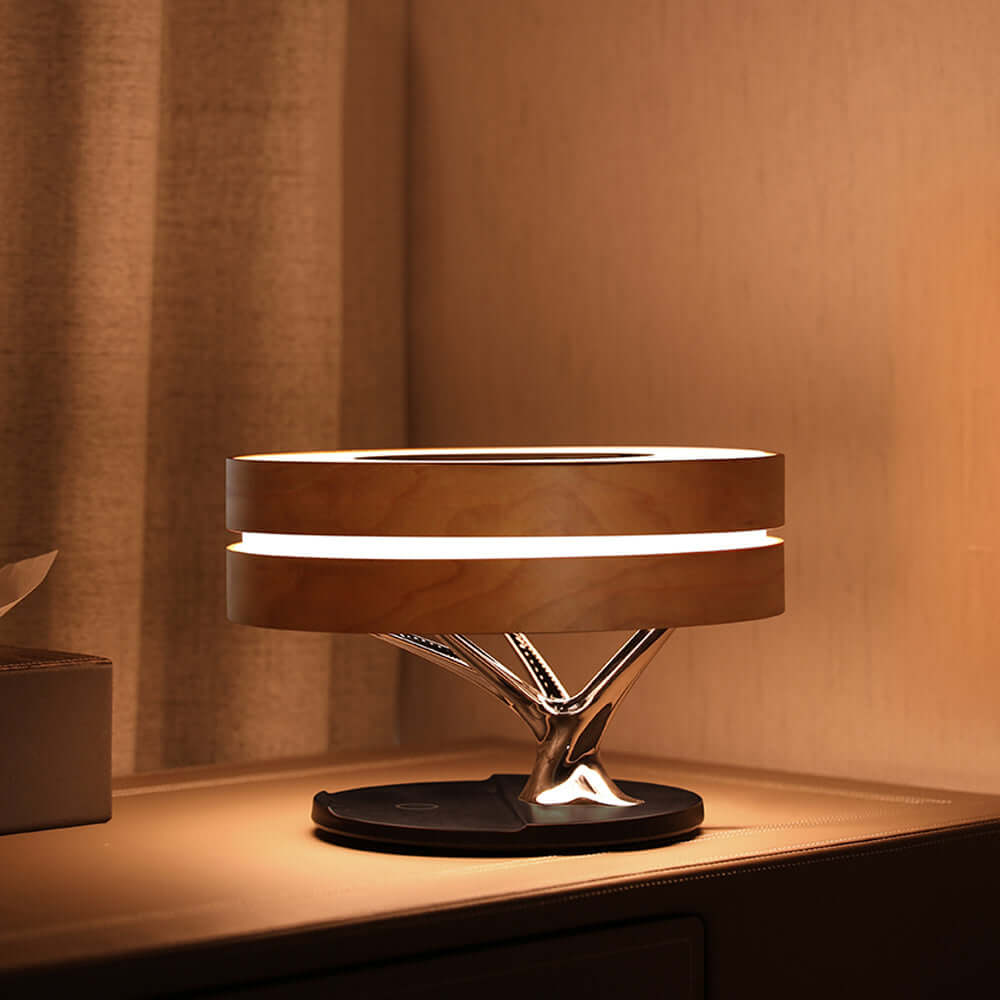 Stylish All in one Intelligent Desk Lamp, Music Box, and Wireless Charger illuminating a modern workspace.