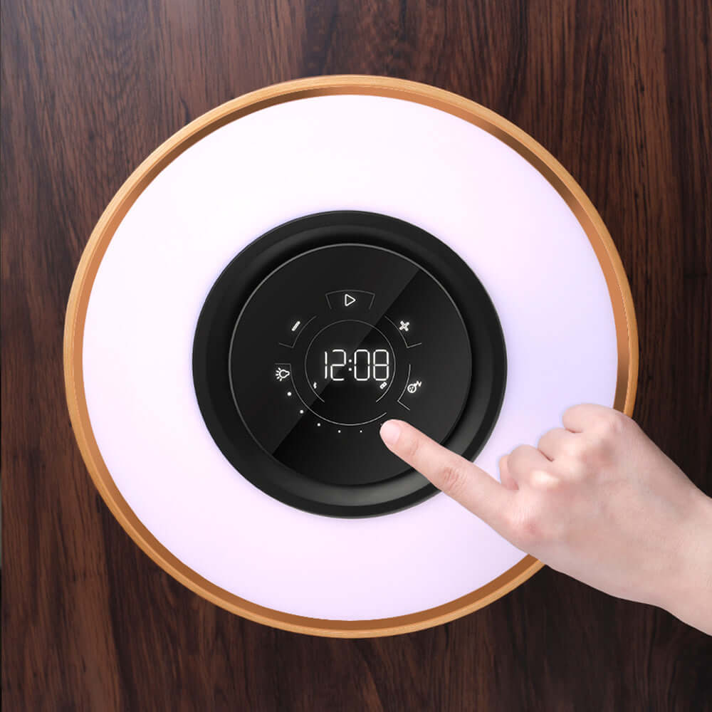 Top view of All-in-One Intelligent Desk Lamp, Music Box, and Wireless Charger with a hand interacting with controls.