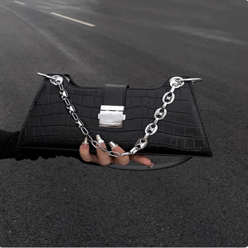 Black Baguette Handbag with stylish chain detail, made from high-quality faux leather, perfect for chic and ethical fashion.