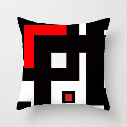 Modern decorative pillow for sofa featuring a bold geometric pattern in black, white, and red.