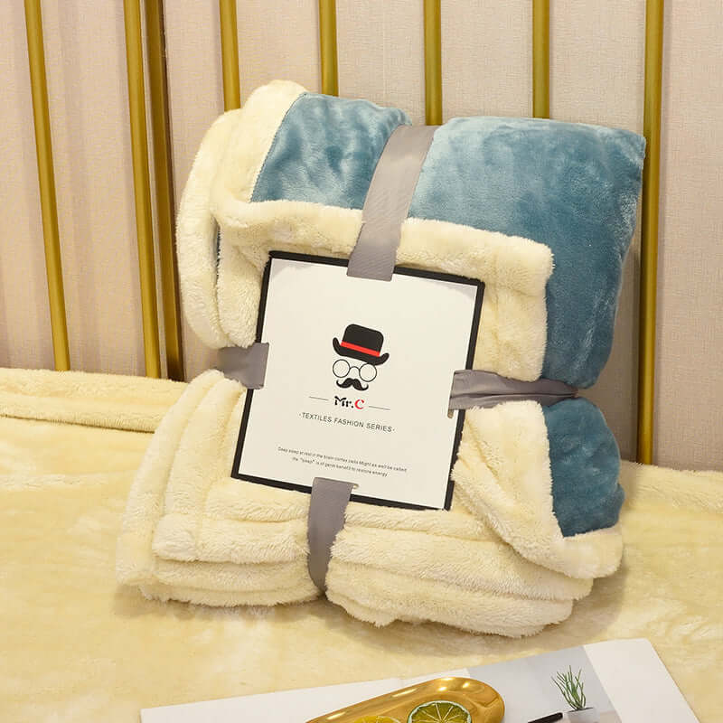 Cozy Flannel Plush Blanket in teal and cream, ideal for warmth and comfort on chilly nights.