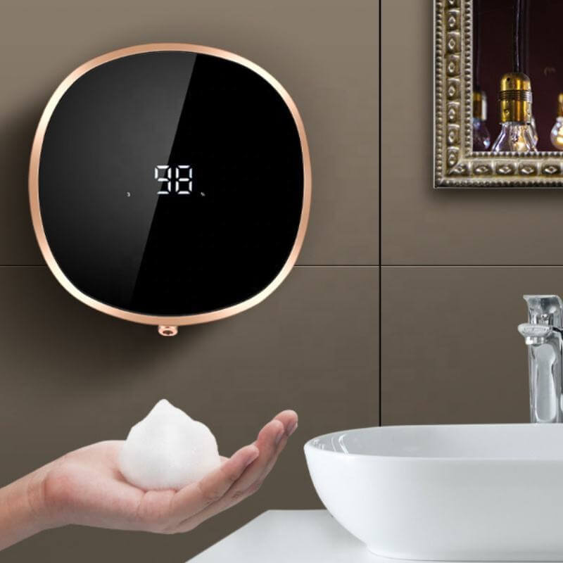 Motion Sensor Soap Dispenser mounted on wall with digital display and a hand dispensing foam soap.
