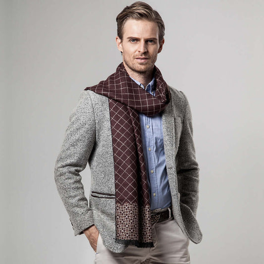 Man wearing a stylish Classic Plaid Warm Scarf over a gray blazer, embodying cozy and fashionable winter style.