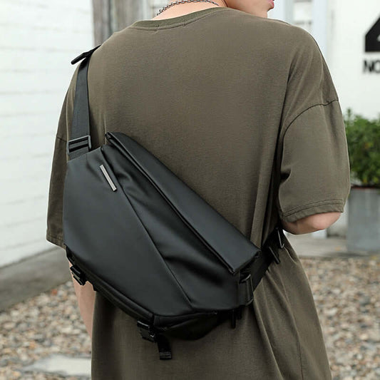 Sleek black crossbody multifunctional bag worn by a person, showcasing its stylish design and durable polyester material.