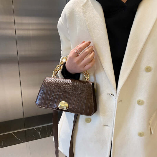 Elegant dark brown Crossbody Messenger Bag Purse with gold chain, worn by person in white coat, perfect for fashion-forward ladies.