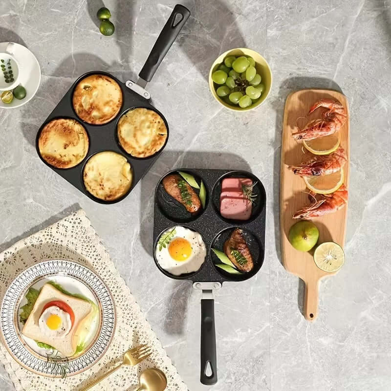 Four Hole Frying Pan with multiple dishes, including eggs and seafood, on a stylish kitchen countertop.