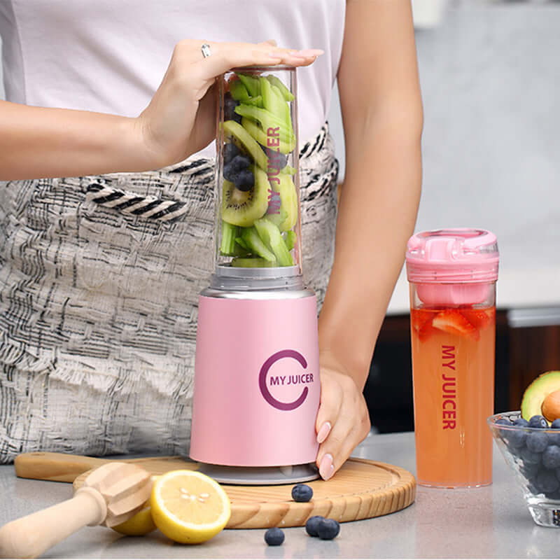 Woman using a pink Multi Function Juicer with fresh fruits, promoting healthy living and culinary ease.