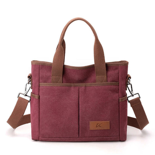 Simple Tote Bag in red canvas with two brown handles and a detachable shoulder strap, ideal for everyday use and available in various colors.