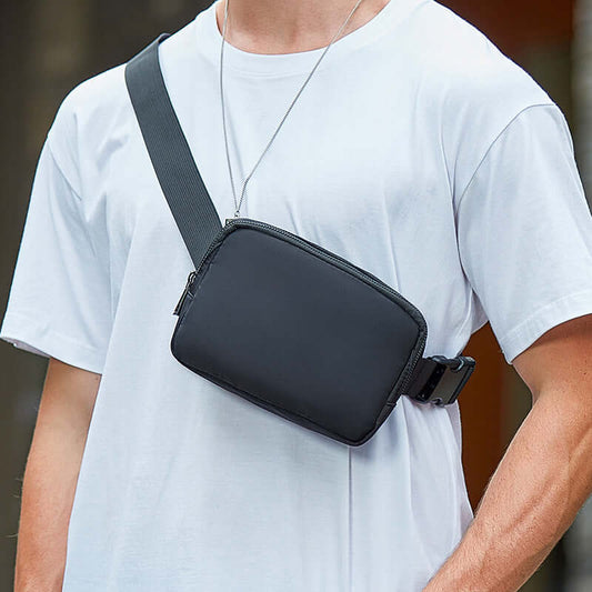Man wearing a sleek black Nylon Crossbody Pouch Bag, lightweight and waterproof, ideal for men seeking style and functionality.
