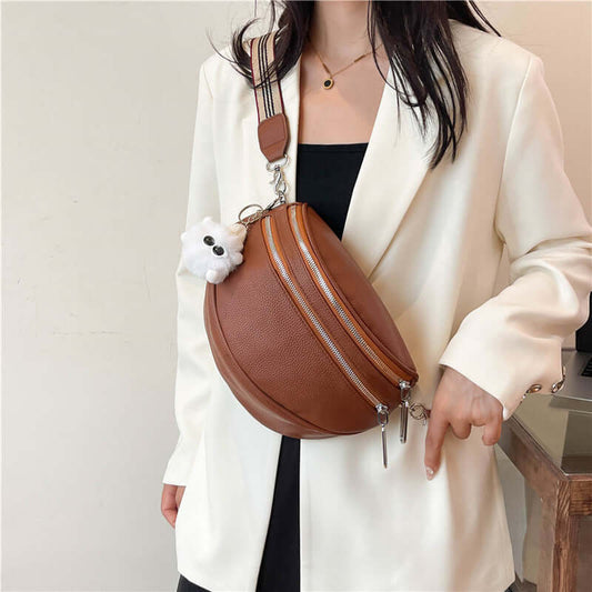 Brown PU ladies chest bag with slit pocket and cute accessory, worn over white blazer by a woman. Urban simplicity style.