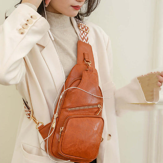 Woman wearing a brown Ladies Cross Shoulder Bag made of PU leather, showcasing its stylish and functional design with multiple pockets.
