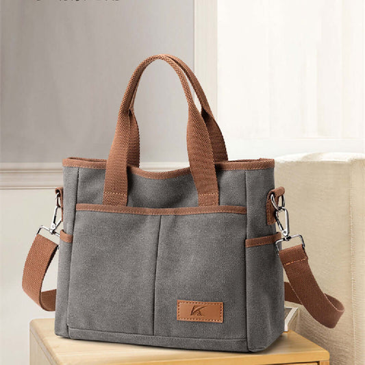 Gray Simple Tote Bag made of durable canvas, featuring brown handles and a versatile design. Ideal for daily use. Available in multiple colors.